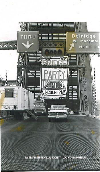 The locked open West Seattle bridge span with the celebration party banner clearly visible in 1984. Neighborhoods within West Seattle were greatly impacted when the bridge was hit by a freighter in 1978. It took six years to get the funds and build the current “high bridge”. (Photo by Chris Styron. SWSHS/Log House Museum 2005.32.343